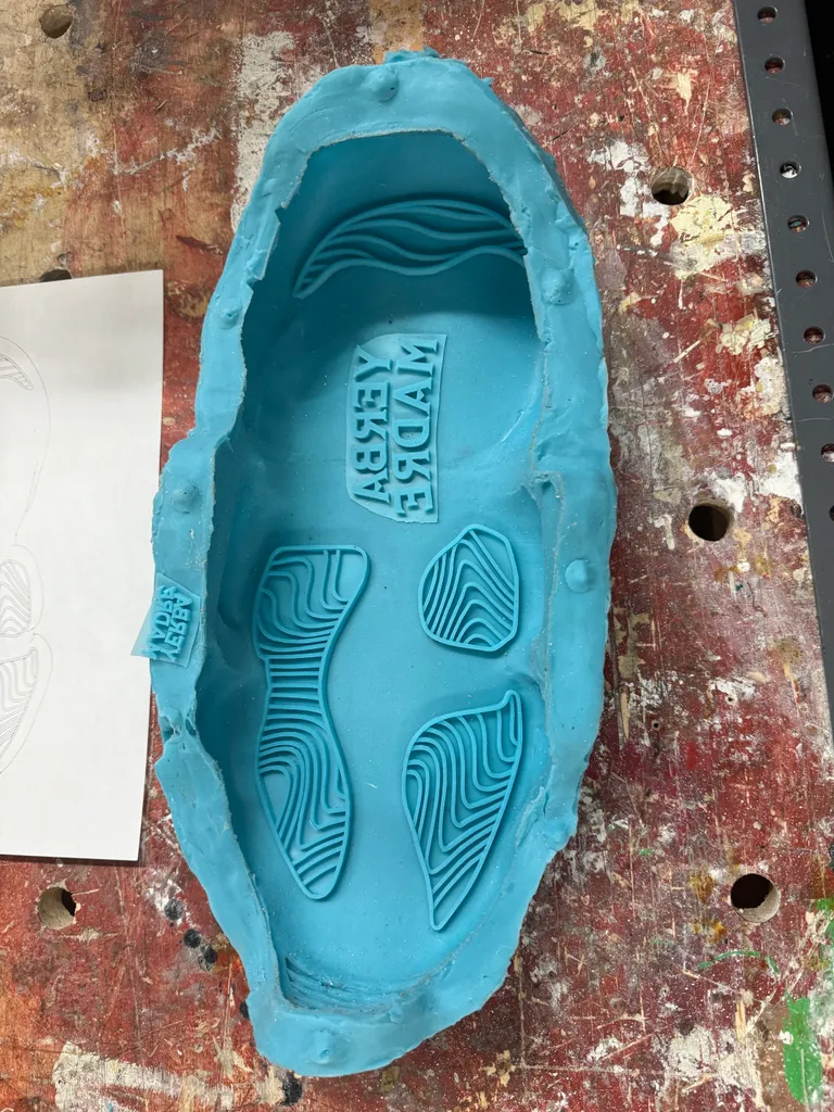 Silicone sole mold showing the Yerba Madre logo and tread texture