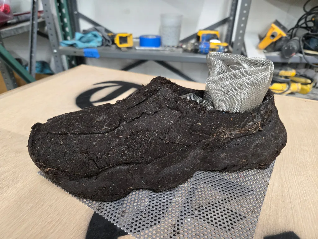 A second-round dirt test cast drying on a mesh rack