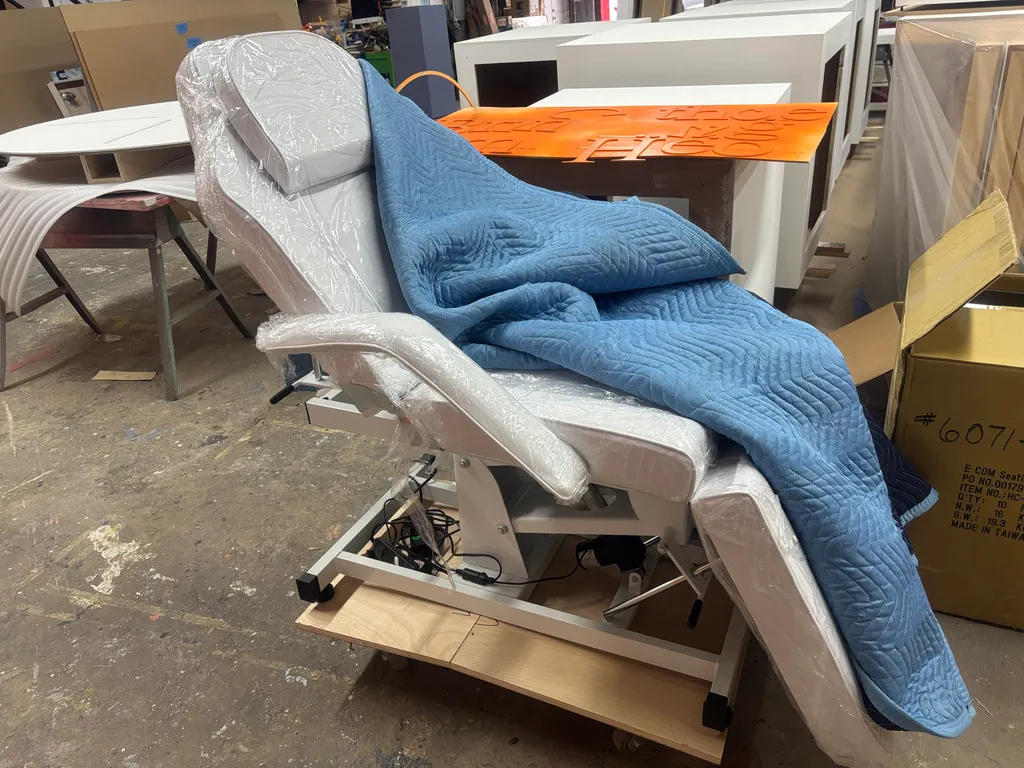 The sourced treatment chair being modified in the shop
