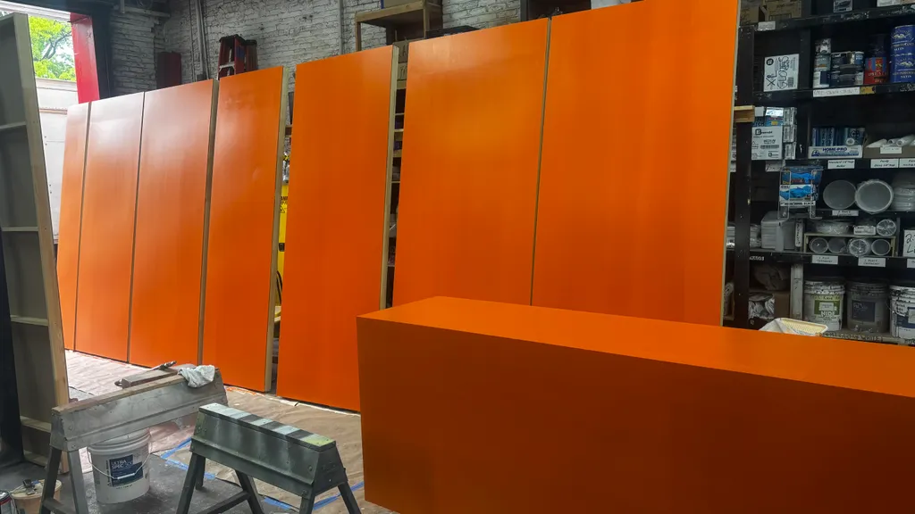 Orange wall flats and cabinets for the exam room set in the shop