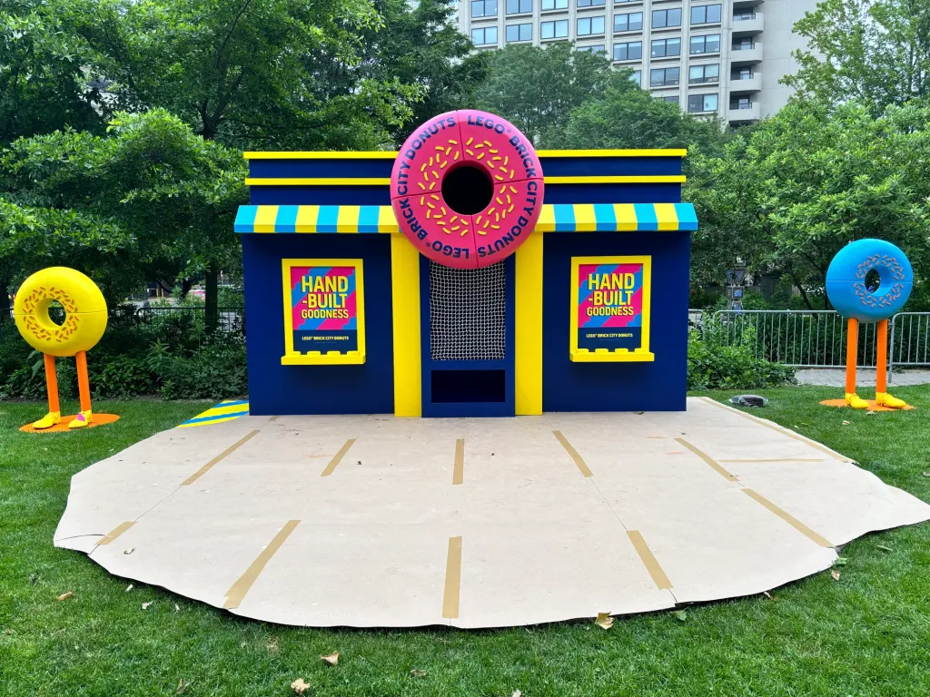The Fill the Donut game building on the Greenway lawn, flanked by two donut characters