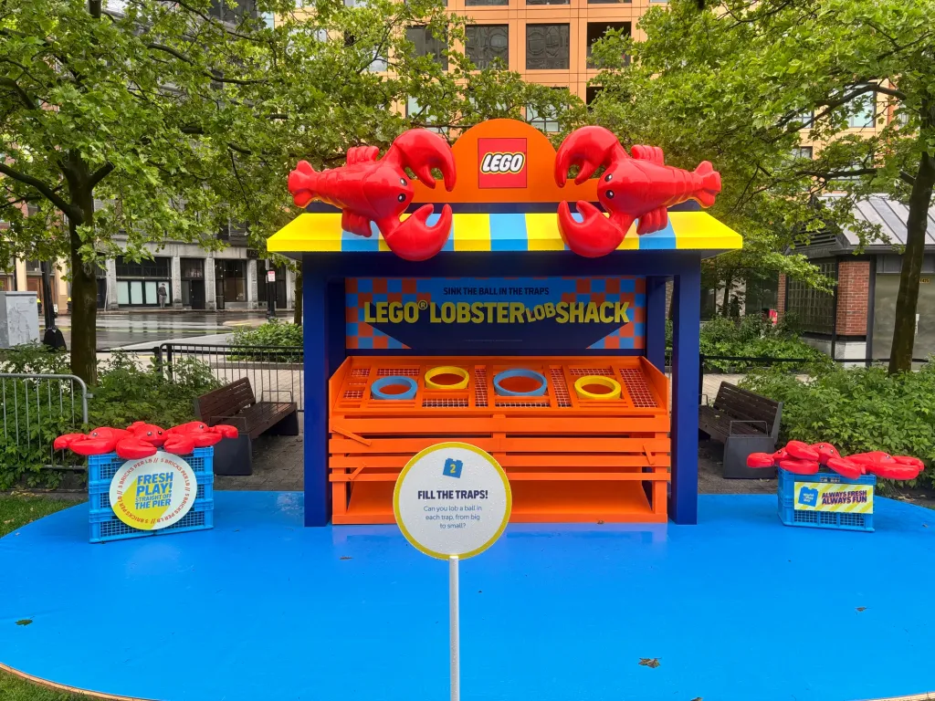 The LEGO Lobster Shack game booth, finished, with red lobsters on the roof