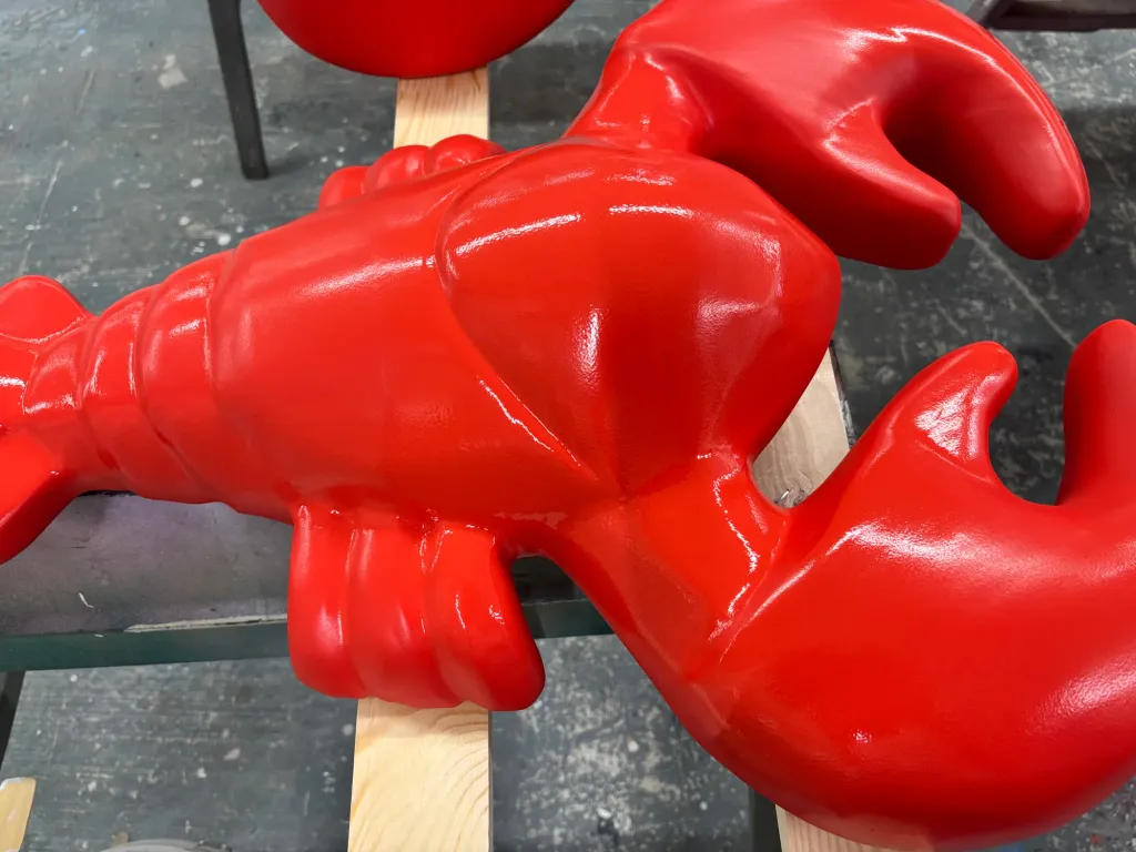 A lobster sculpture after its red paint finish