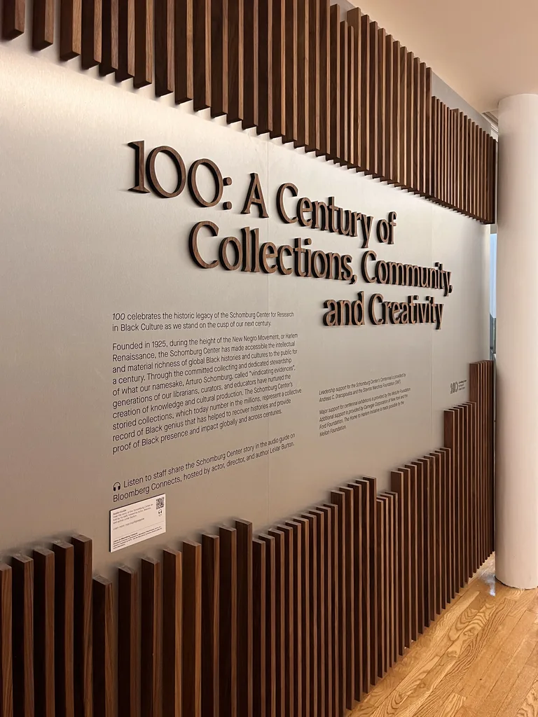 Walnut slats and brushed aluminum on the exhibition intro wall